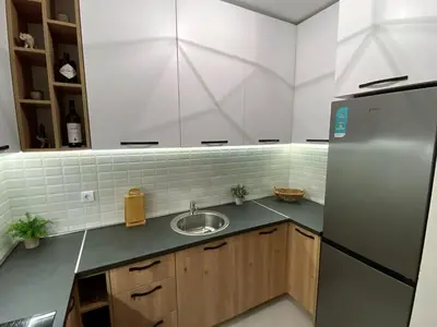 a kitchen with a sink and a refrigerator at MonteRelax Apartments Becici in Rafailovici