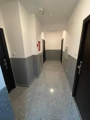 a hallway of an empty room with two doors at MonteRelax Apartments Becici in Rafailovici
