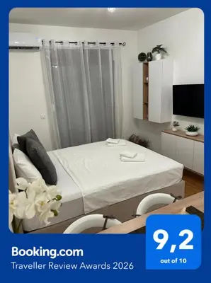 a hotel room with a bed and a tv at MonteRelax Apartments Becici in Rafailovici