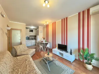 a living room with a couch and a tv at Beachfront Apartments Oaza 2 in Petrovac na Moru