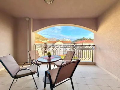 a patio with a table and chairs on a balcony at Beachfront Apartments Oaza 2 in Petrovac na Moru