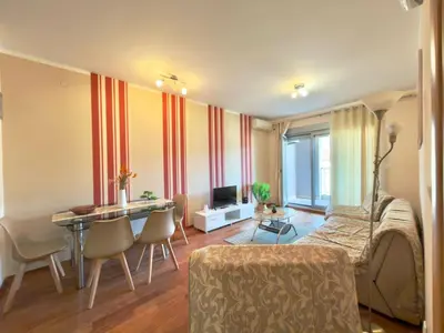 a living room with a table and a dining room at Beachfront Apartments Oaza 2 in Petrovac na Moru
