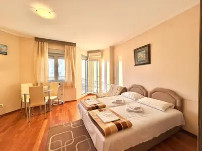 a bedroom with a bed and a table in it at Beachfront Apartments Oaza 2 in Petrovac na Moru