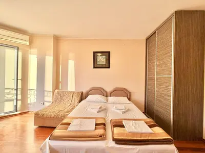 a bedroom with two beds and a large window at Beachfront Apartments Oaza 2 in Petrovac na Moru