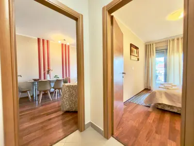a hallway with a door leading to a dining room at Beachfront Apartments Oaza 2 in Petrovac na Moru