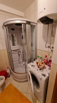 a washing machine in a bathroom with a shower at Apartman Elijana in Budva
