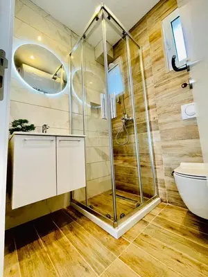 a bathroom with a shower and a toilet at Garden Villas in Donji Štoj