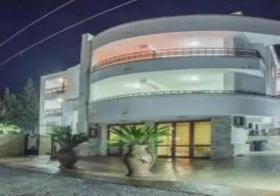 a large building with two potted plants in front of it at Villa M in Dobra Voda