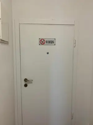 a white door with a no smoking sign on it at Corall apartment Bar in Bar