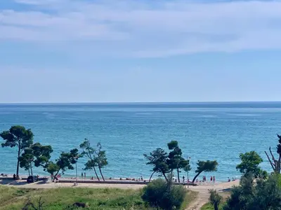 a beach with people on the sand and the ocean at Corall apartment Bar in Bar