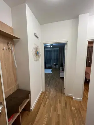 a hallway with white walls and a wooden floor at Corall apartment Bar in Bar