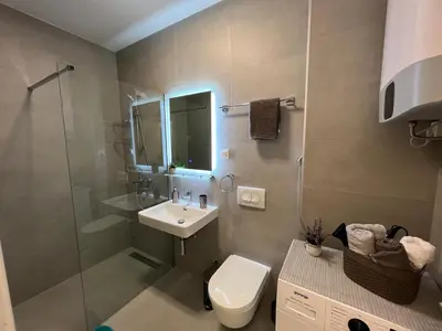 a bathroom with a sink and a toilet and a shower at Corall apartment Bar in Bar