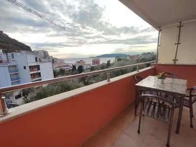 a balcony with a table and chairs and a view at Apartmani Tomić 4* in Rafailovici