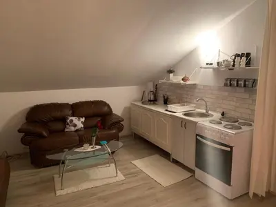 a kitchen with a couch and a stove and a sink at Prima House in Podgorica