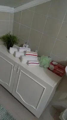 a white counter in a bathroom with towels on it at Prima House in Podgorica