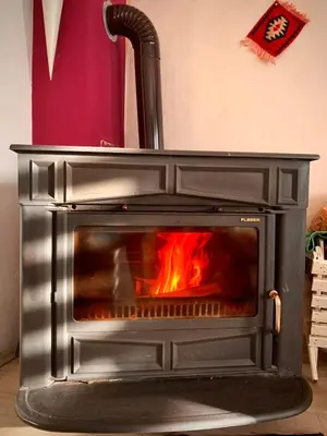 a stove with a fire inside of it at Prima House in Podgorica