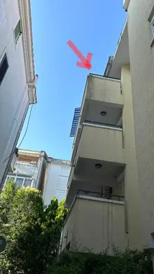 a red kite is flying above a building at Apartman Luka Budva in Budva