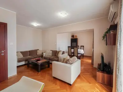 a living room with a couch and a table at Sunny three-bedroom apartment in Budva in Budva