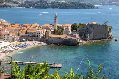 a group of people on a beach in the water at Sunny three-bedroom apartment in Budva in Budva