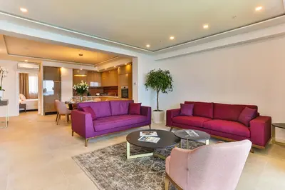 a living room with purple couches and a table at Sunraf Luxe Apartments in Budva