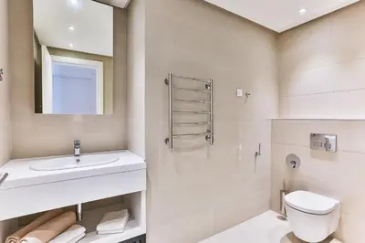 a bathroom with a sink toilet and a mirror at Sunraf Luxe Apartments in Budva