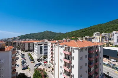 an aerial view of a city with buildings and a mountain at Cozy studio with terrace in Budva