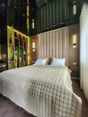 a bedroom with a large bed with a white comforter at Harmony Apartments in Podgorica
