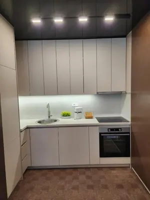 a kitchen with white cabinets and a sink at Harmony Apartments in Podgorica