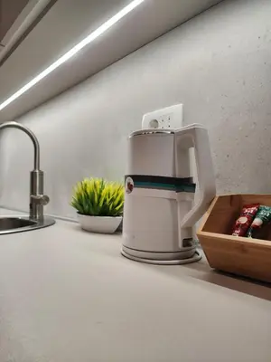 a coffee maker on a kitchen counter next to a sink at Harmony Apartments in Podgorica