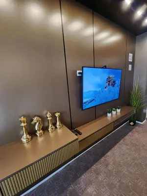 a living room with a tv on a wall at Harmony Apartments in Podgorica