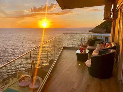 a balcony on a cruise ship with a sunset at Apartment Your Home in Dobra Voda