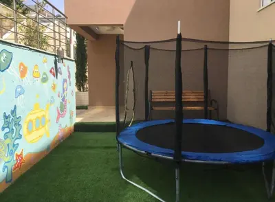 a trampoline in the corner of a building at Apartment Your Home in Dobra Voda