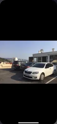 a white car is parked in a parking lot at Apartment Your Home in Dobra Voda