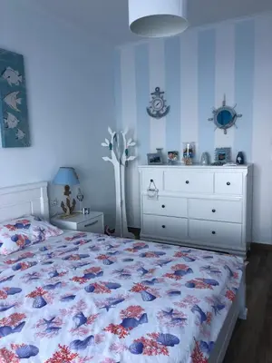 a bedroom with a bed and a white dresser and a bed sidx sidx sidx at Apartment Your Home in Dobra Voda
