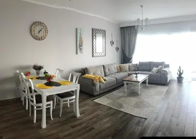 a living room with a couch and a table at Apartment Your Home in Dobra Voda