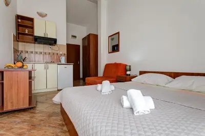 a bedroom with a bed with towels on it at Villa Savovic in Petrovac na Moru