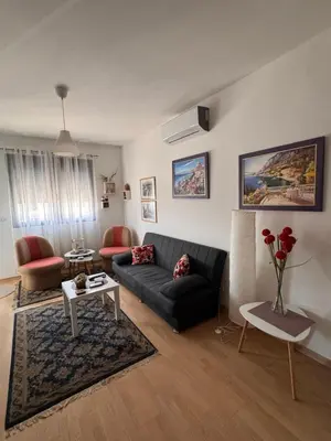 a living room with a couch and a table at Flower and Love Flat Next to centar of podgorica in Podgorica