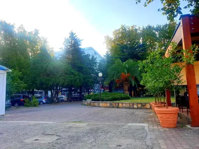 a park with trees and a building and a street at LUX Apartment - Central Place Bar in Bar