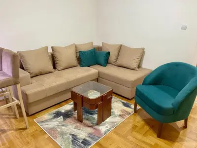 a living room with a couch and a chair at RIO 1 in Podgorica
