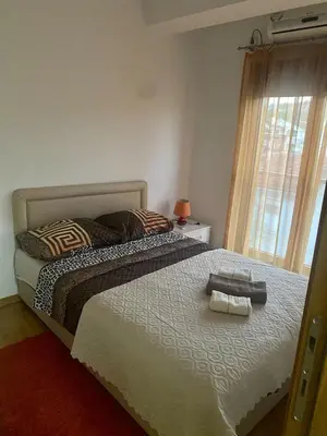 a bedroom with a bed with two towels on it at RIO 2 in Podgorica