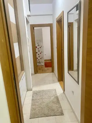 a hallway with a mirror and a door with a rug at RIO 2 in Podgorica