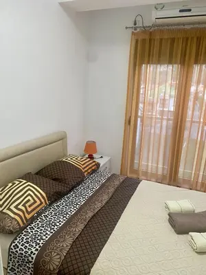 a bedroom with two beds and a window at RIO 2 in Podgorica