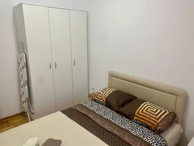 a bedroom with a bed with two pillows on it at RIO 2 in Podgorica