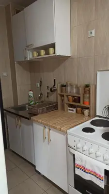 a kitchen with a stove and a counter top at Martha`s place Drač in Podgorica