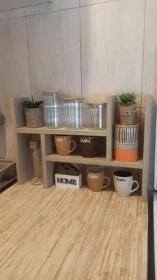 a shelf with potted plants on it in a room at Martha`s place Drač in Podgorica