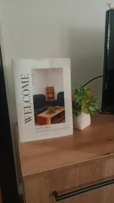 a magazine sitting on top of a wooden table at Martha`s place Drač in Podgorica