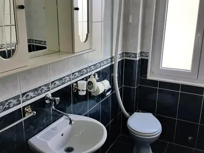 a bathroom with a toilet and a sink at Centre Point Apartment in Podgorica