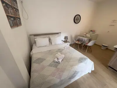 a bedroom with a bed with two towels on it at CASA APARTMENTS, one-bedroom apartment in Budva