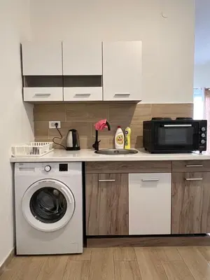 a kitchen with a washing machine and a microwave at CASA APARTMENTS, one-bedroom apartment in Budva