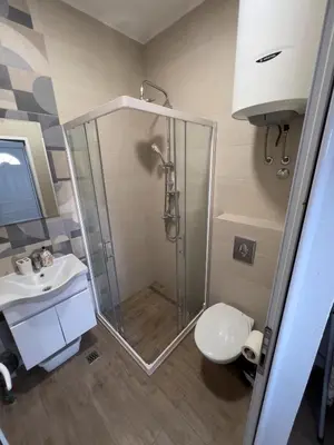 a bathroom with a shower and a toilet and a sink at CASA APARTMENTS, one-bedroom apartment in Budva